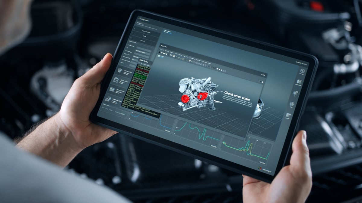 Mechanic performing wireless vehicle diagnostics with tablet